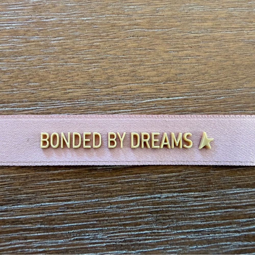Golden Goose Pink Bracelet with Gold Lettering “Bonded by Dreams”